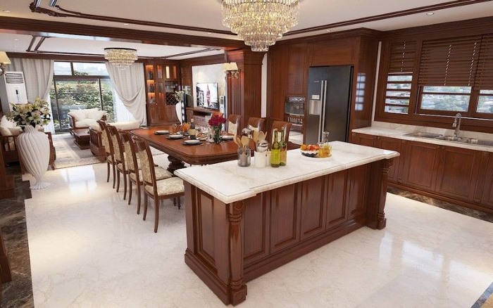 Phòng ăn sử dụng toàn bộ nội thất gỗ. Riêng mặt bàn phòng bếp được thiết kế gạch đá bóng sạch sẽ, giúp dễ dàng lau chùi. 